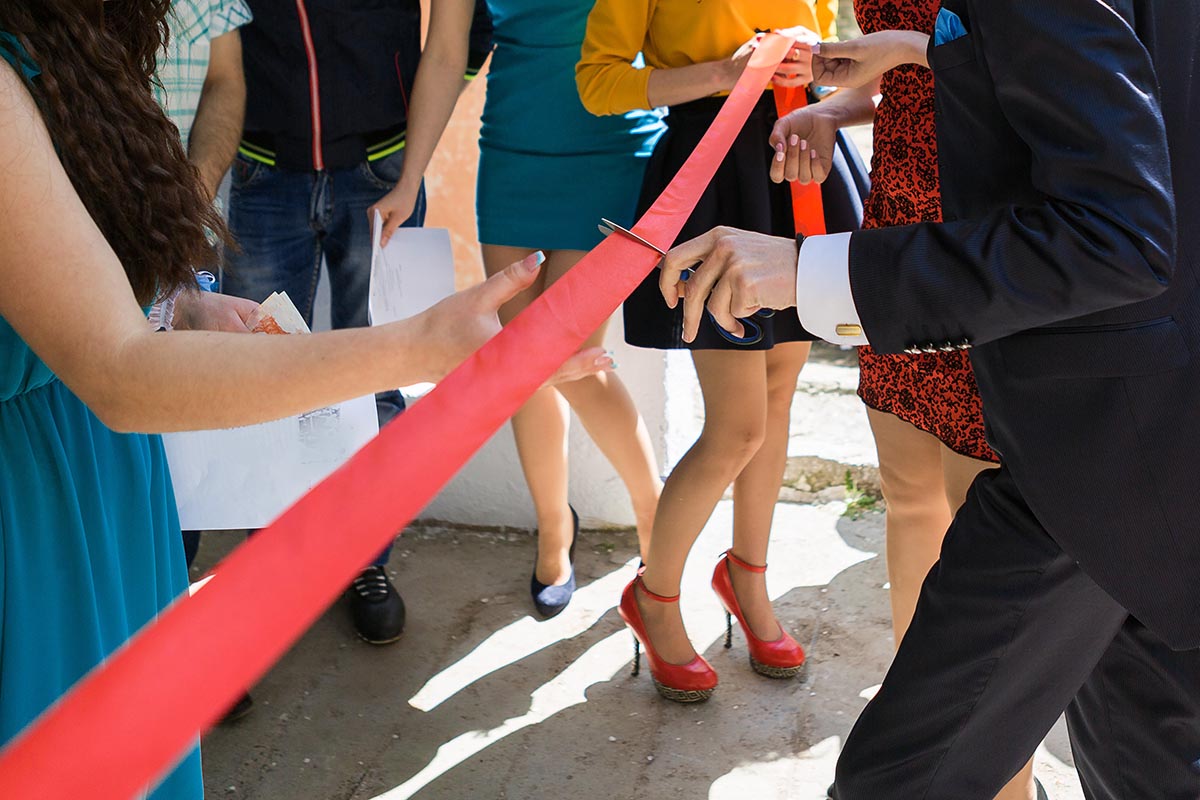 Cutting a red ribbon with scissors, inaugurated ribbon