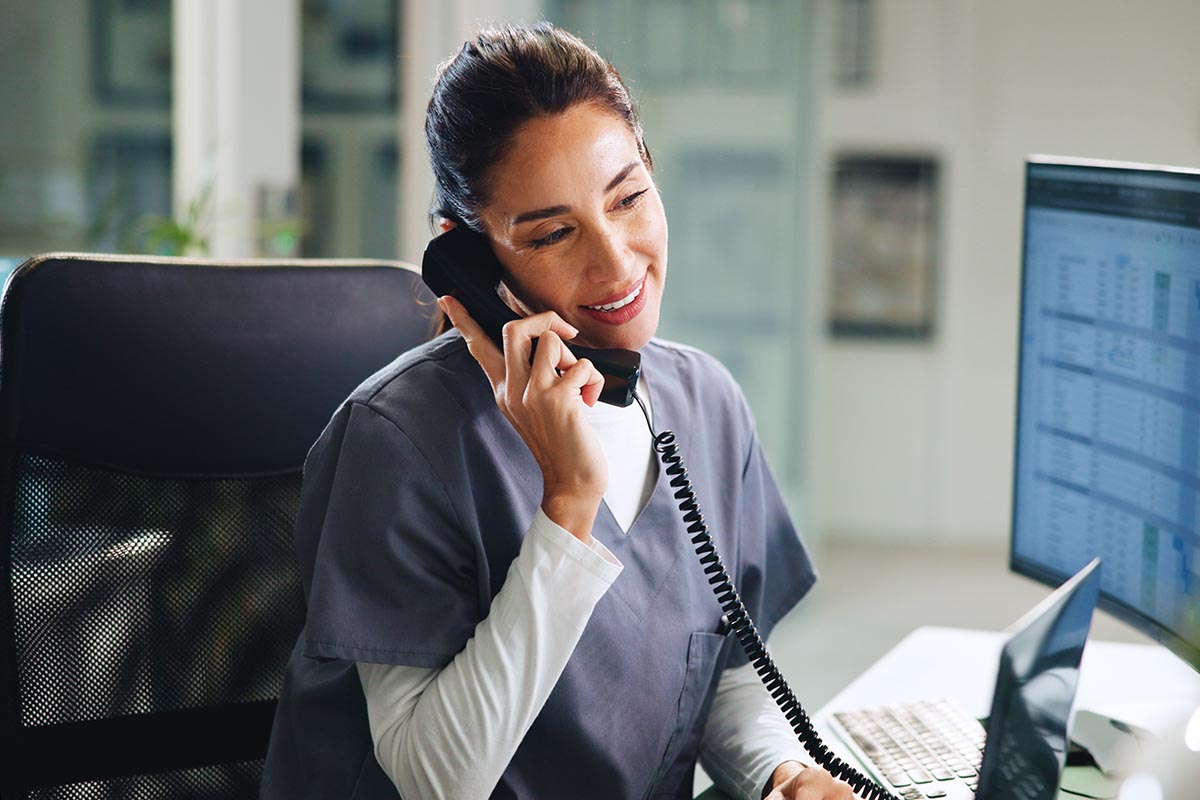 Woman, doctor or phone call in hospital with smile, medical consultation or update patient appointment. Healthcare, surgeon or talk at tech for schedule, referral confirmation or help at front desk.