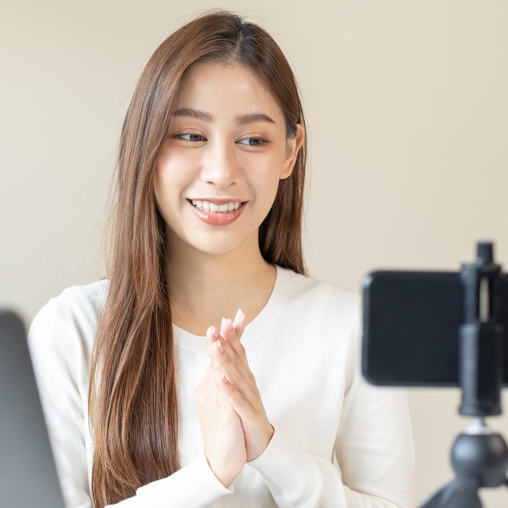 Vlogger influencer, attractive asian young woman blogger, content maker looking at camera, recording interview on smartphone, talk on video shoot social media, live broadcast with technology at home.